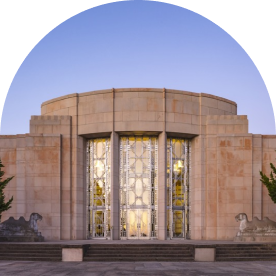 Art deco facade of Seattle Asian Art Museum's entrance with sunset reflecting off of it.